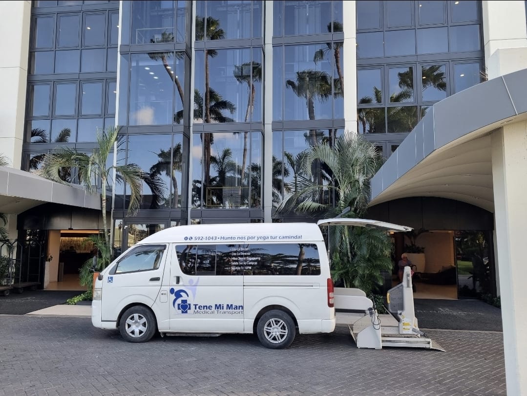 Wheelchair-accessible van with its lift lowered at a hotel entrance